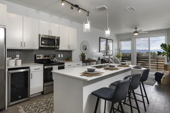 Chef style kitchen layout with farmhouse stainless steel deep sink